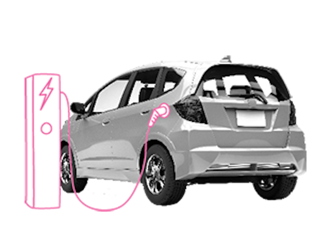 Ein E-Auto hängt an einer Ladesäule und wird geladen.