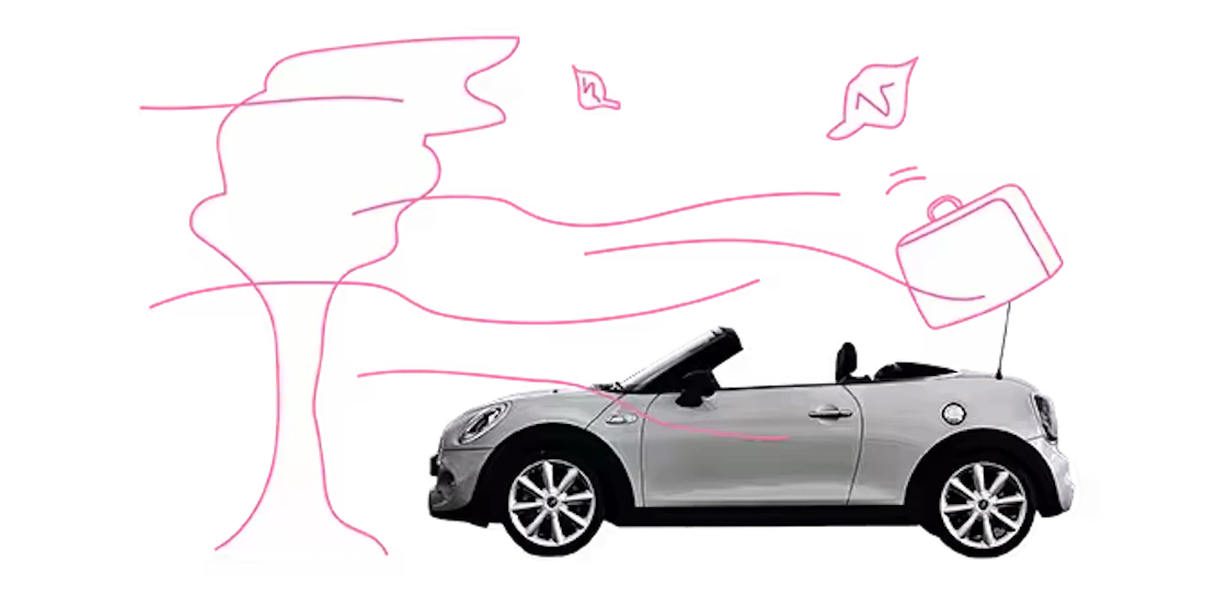 Auto fährt bei Sturm und es fliegen Dinge umher.